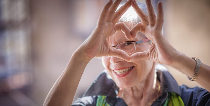 Senior woman making heart with hands