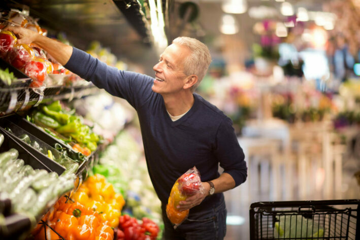 senior male shopping in grocery store